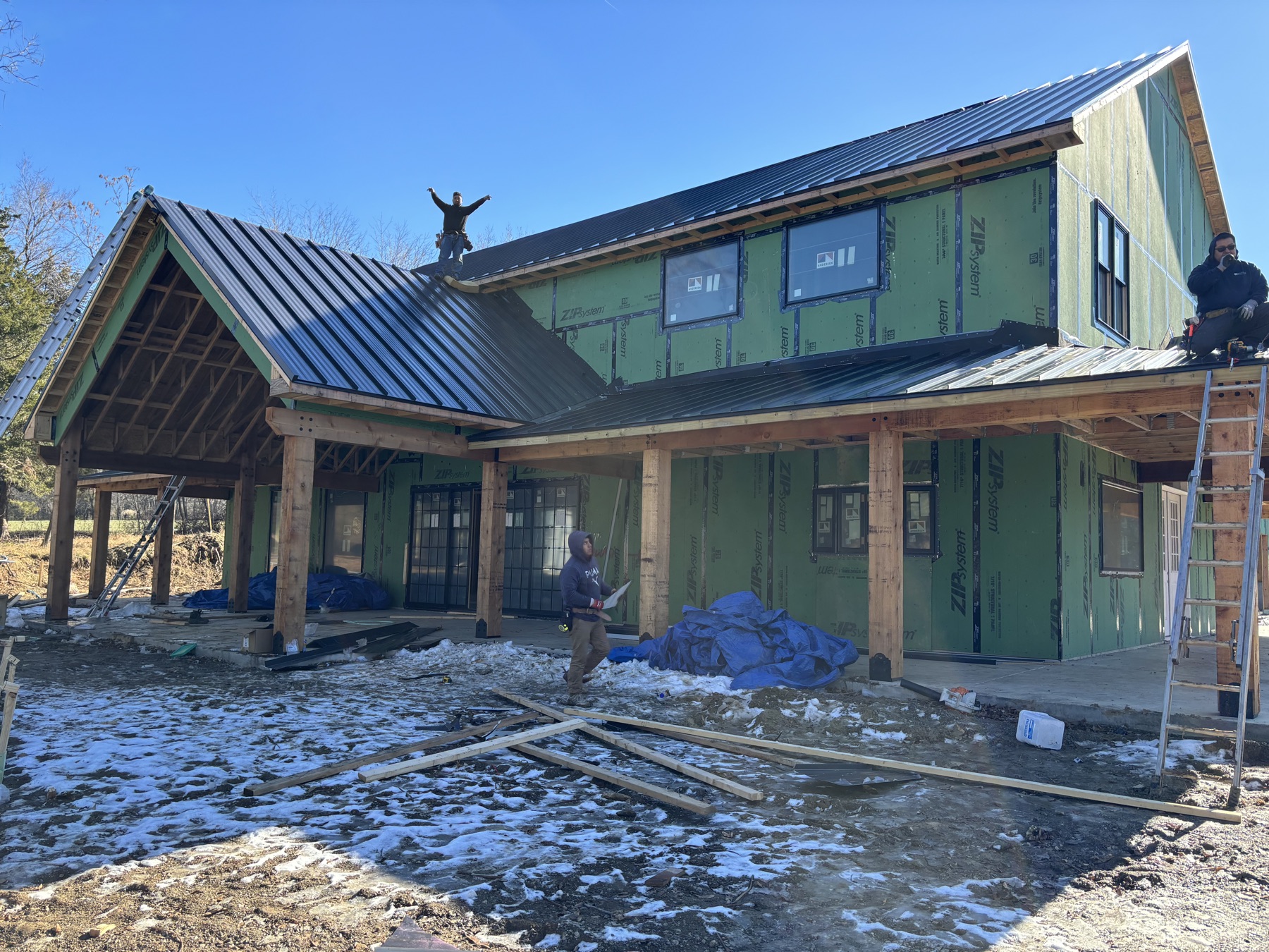 A Barnhouse Structures crew framing and roofing a building in progress